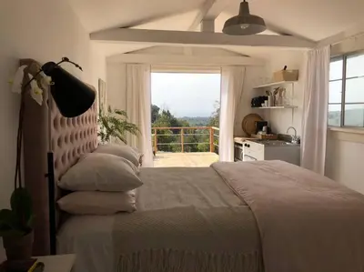 a bedroom with a bed with a large window at 30 PCT OFF! Malibu Charming Suite, Ocean View, King Bed in Malibu