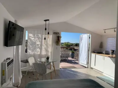 a living room with a table and chairs and a kitchen at 30 PCT OFF! Malibu Serene Cabin, Ocean View, Beach in Malibu