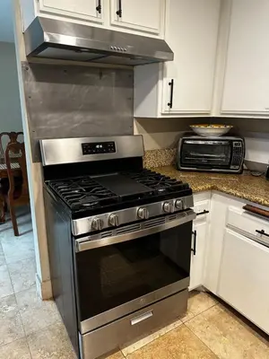 a kitchen with a stove top oven in a kitchen at Buxton Private Room and Bath Wheel Chair Access in Rialto