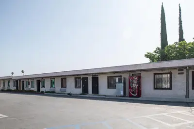 an empty parking lot in front of a building at Starlite Motel in San Bernardino