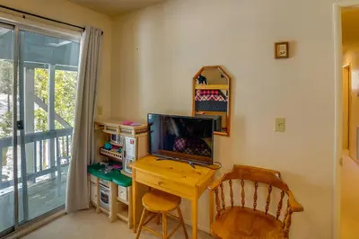 a desk with a computer and a chair in a room at Peaceful Pines Running Springs Home with 3 Decks in Running Springs
