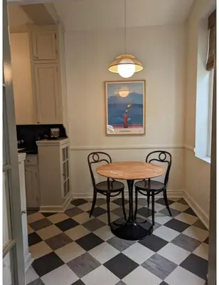 a dining room with a table and chairs on a checkered floor at Villa Carlotta - 30 Day Requirement in Los Angeles