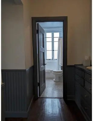 a bathroom with a door open to a bathroom with a toilet at Villa Carlotta - 30 Day Requirement in Los Angeles