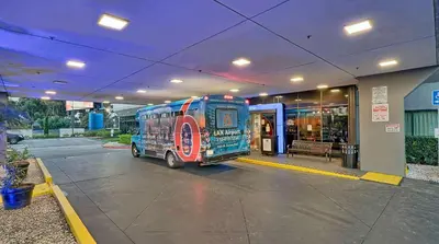 a van parked in front of a building at Suites Los Angeles CA Los Angeles LAX in Inglewood