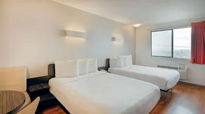 a hotel room with two beds and a window at Suites Los Angeles CA Los Angeles LAX in Inglewood