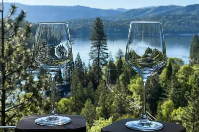 two wine glasses sitting on top of a table at Surreal Feel Lakeview Chalet in Lake Arrowhead