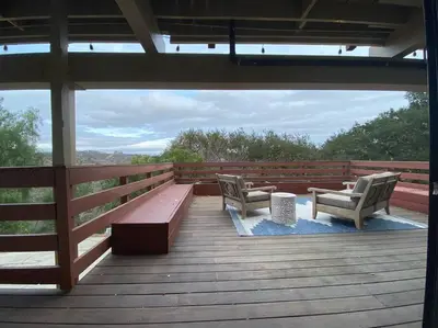 two chairs and a bench on a wooden deck at Apartment with Private Deck & Mountain Views in Topanga