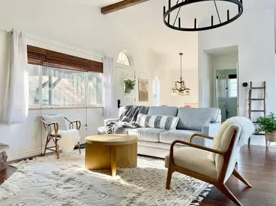 a living room with a couch and a table at @wild_olive_den ~ Serene Weekend Getaway Cabin in Running Springs