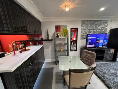 a kitchen with a table and a television in it at Updated Gorgeous studio condo in West Hollywood with Pool in Los Angeles