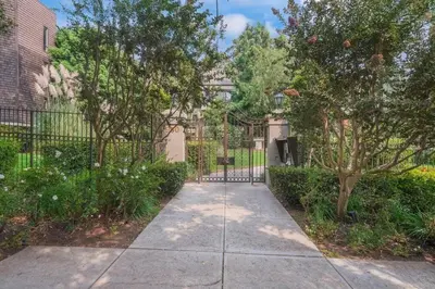 a driveway with a gate in front of a building at Updated Gorgeous studio condo in West Hollywood with Pool in Los Angeles