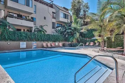 a swimming pool in front of a building at Updated Gorgeous studio condo in West Hollywood with Pool in Los Angeles