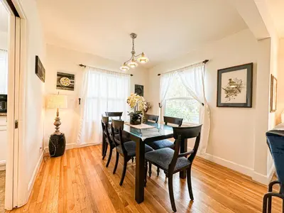 a dining room with a black table and chairs at Charming 3BR House - Hal-UC in Los Angeles