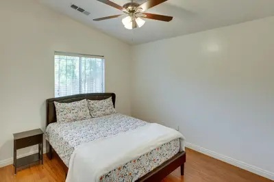 a bedroom with a bed and a ceiling fan at Pet-Friendly California Retreat with Fenced-In Yard! in Bakersfield