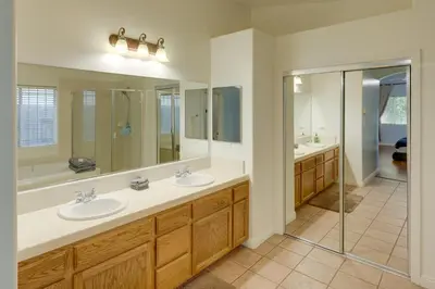 a bathroom with two sinks and a shower at Pet-Friendly California Retreat with Fenced-In Yard! in Bakersfield