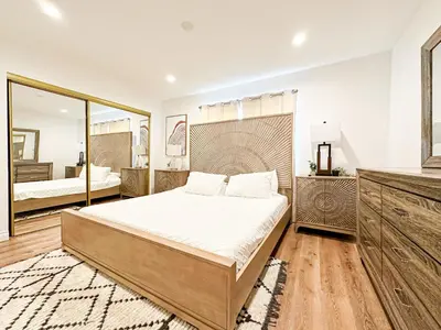 a bedroom with a large bed and a mirror at Hollywood Habitat - BR11-WH in Los Angeles