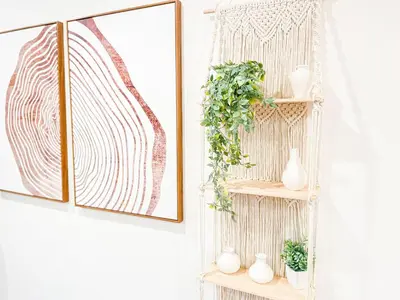 a shelf with vases and plants on it next to two pictures at Hollywood Habitat - BR11-WH in Los Angeles