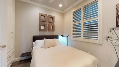 a bedroom with a bed and a window at 3 Bedroom 2 Bath Beachfront Home in Huntington Beach