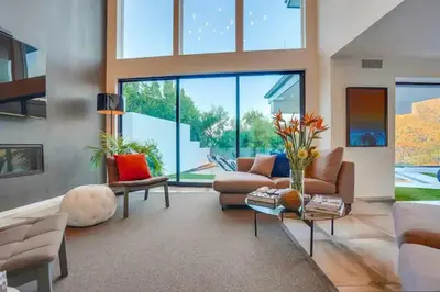 a living room filled with furniture and a large window at Troy Hill in Los Angeles