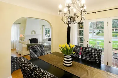 a dining room with a table and chairs and a room with a couch at Charming Pasadena English Cottage on Tree Lined Street in Pasadena