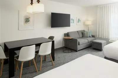 a living room with a table and a couch at TownePlace Suites by Marriott Lancaster in Lancaster