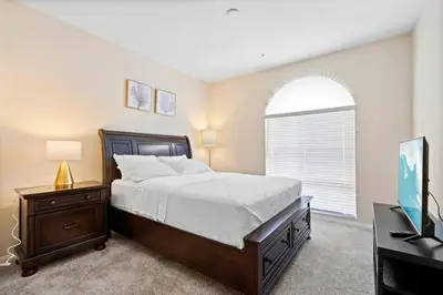 a bedroom with a bed and a desk and a television at Lovely & coxy 2BR/2BA! 5MIN to Disney! in Anaheim