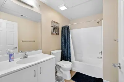 a white bathroom with a sink and a toilet at Lovely & coxy 2BR/2BA! 5MIN to Disney! in Anaheim