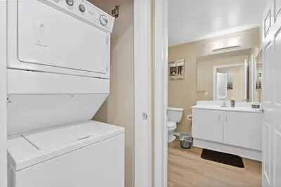 a white bathroom with a sink and a toilet at Lovely & coxy 2BR/2BA! 5MIN to Disney! in Anaheim
