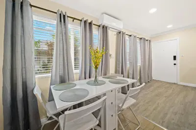 a dining room with a table and chairs and a window at Cozy & Serene ~ 12mins to Downtown LA in Alhambra