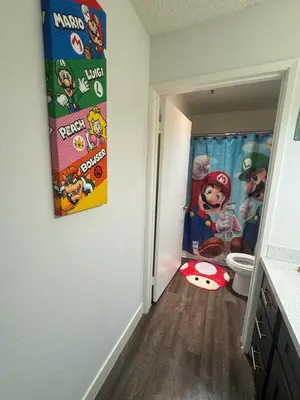 a bathroom with a cartoon mural on the wall at Mario, Disney & not themed Loft Universal Studios 10min loft apartment in Los Angeles