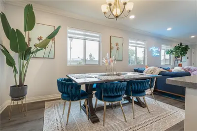 a dining room and living room with a table and chairs at Angel & Rose * Hollywood DTLA in Los Angeles