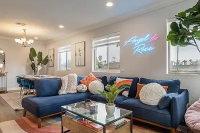 a living room with a blue couch and a table at Angel & Rose * Hollywood DTLA in Los Angeles