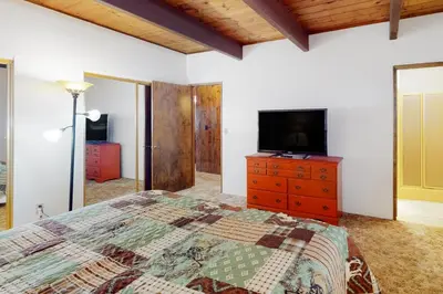 a bedroom with a bed and a television on a dresser at Rocky Pines in Twin Peaks