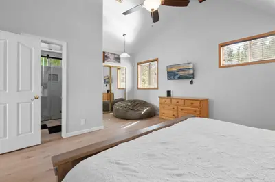 a bedroom with a bed and a ceiling fan at 3 Cubs Lakefront - Stunning lakeside home with Hot Tub, Foosball, and Lake View in Big Bear Lake