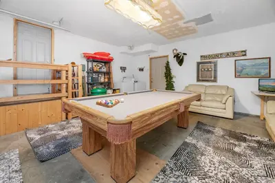 a living room with a pool table in it at Abe's Cool Cabin - Nice luxury home with a game room, hot tub, and pool table in Big Bear Lake