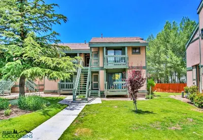 a house with a staircase in the yard at Bayview Condo - Condo is cozy and a great location for kayaking and paddle boarding! in Big Bear Lake