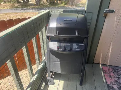 a trash can sitting next to a fence at Bayview Condo - Condo is cozy and a great location for kayaking and paddle boarding! in Big Bear Lake