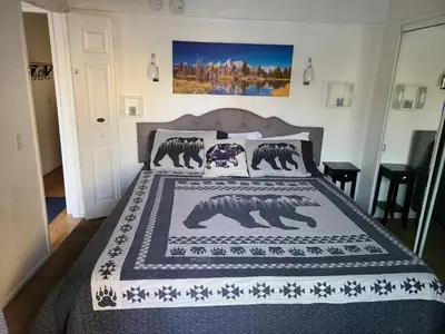 a bedroom with a bed with a bear blanket at Bayview Condo - Condo is cozy and a great location for kayaking and paddle boarding! in Big Bear Lake