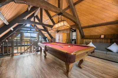a pool table in the middle of a room at Alpine Lakefront - Lakefront cabin and all the amenities really fun from the pool table and spa in Big Bear Lake