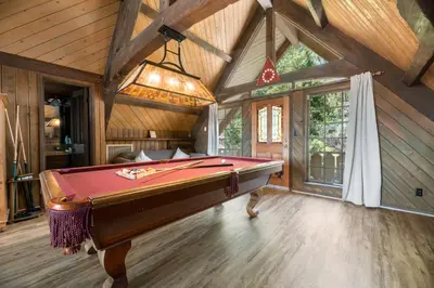 a billiard room with a pool table in it at Alpine Lakefront - Lakefront cabin and all the amenities really fun from the pool table and spa in Big Bear Lake