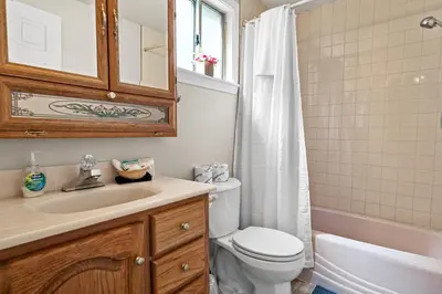 a bathroom with a toilet and a sink and a shower at Apples Delight -WALK TO THE LAKE! Enjoy the huge backyard with lovely forest views ! in Big Bear Lake