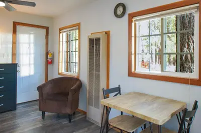 a dining room with a table and a chair at Baby Bear - A delightful studio style property in the perfect central location! in Big Bear Lake