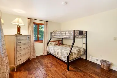 a bedroom with a bunk bed and a dresser at Bear Claw Cabin - Perfect location with an amazing game room and hot tub! in Big Bear Lake