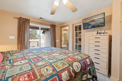 a bedroom with a bed and a dresser and a window at Bear Family Cabin - Stay together & play together! Foosball, billiards, hot tub, walk to lake! in Big Bear Lake