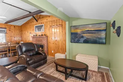 a living room with leather furniture and a fireplace at Bear Paw Cabin - Cozy and quaint, the perfect mountain getaway! in Big Bear Lake