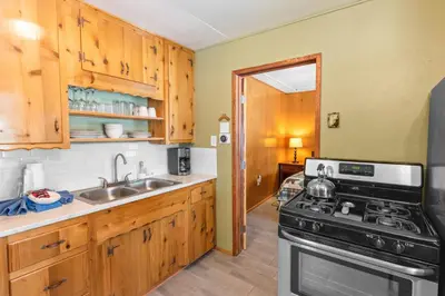 a kitchen with a stove and a sink at Bear Paw Cabin - Cozy and quaint, the perfect mountain getaway! in Big Bear Lake