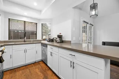 a kitchen with white cabinets and a counter top at Bear Retreat - Modern location within walking distance to Snow Summit with a private hot tub! in Big Bear Lake