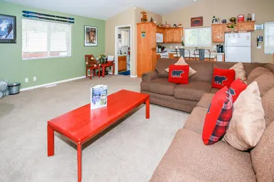 a living room with a couch and a table at Ben's Cool Cabin - Phenomenal views and an ideal location close to all the local attractions! in Big Bear Lake