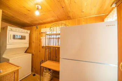 a kitchen with a refrigerator and a stove at Big Bear Retreat - A charming mountain cabin with easy access to Big Bear's attractions! in Big Bear Lake