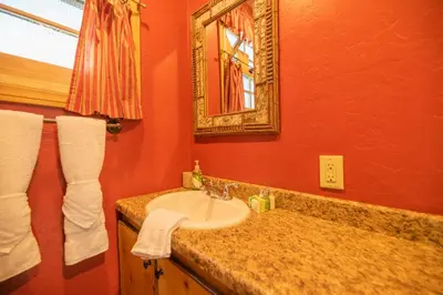 a bathroom with a sink and a mirror at Big Bear Retreat - A charming mountain cabin with easy access to Big Bear's attractions! in Big Bear Lake