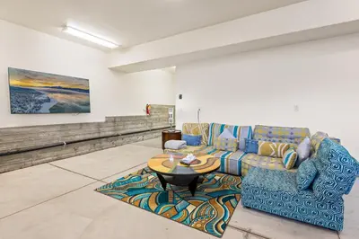 a living room with a couch and a table at Boulder Bay Chalet Lakefront - Elegantly decorated with Hot Tub and Game Room! in Big Bear Lake